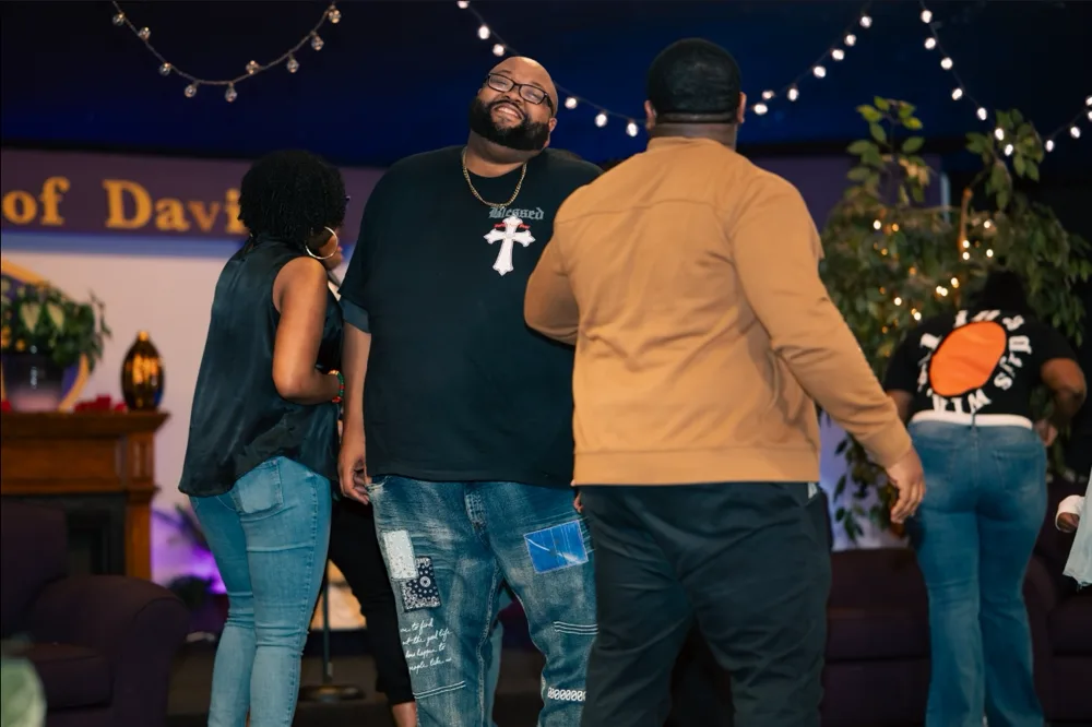 T.L.C.W.E. team members embracing in joyful fellowship during The Release, Phase 2